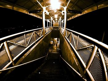 View of illuminated footbridge at night