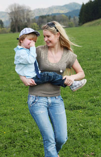 Mother and son playing on field