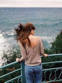 Rear view of woman looking at sea