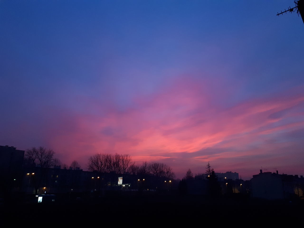 SILHOUETTE CITYSCAPE AGAINST SKY AT SUNSET