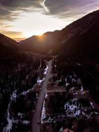 Road amidst mountains against sky during sunset