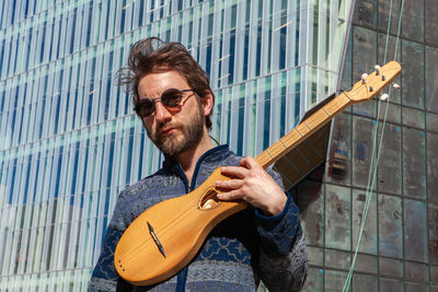 Portrait of man wearing sunglasses standing outdoors