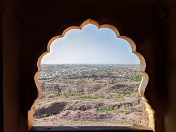 Panoramic view seen through arch window of historic fort of jodhpur
