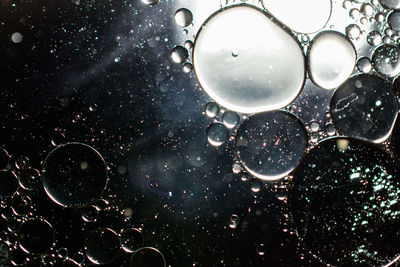 Close-up of bubbles against water