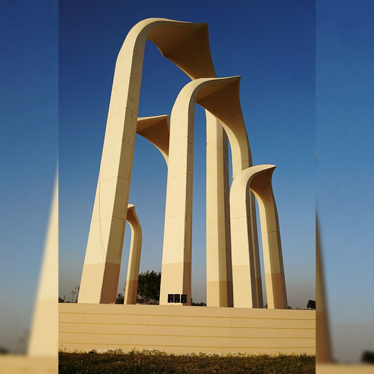 architecture, clear sky, day, blue, outdoors, no people, low angle view, sky, built structure, architectural column, sunlight, building exterior, nature