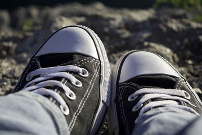 Low section of man wearing canvas shoes