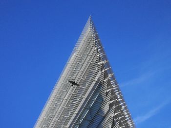 Low angle view of modern building against clear blue sky