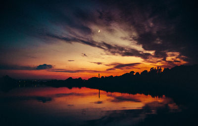 Scenic view of lake against romantic sky at sunset