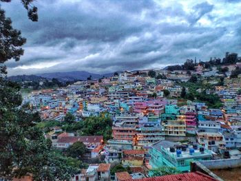 High angle shot of townscape against cloudy sky