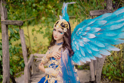 Portrait of young woman wearing hat standing outdoors