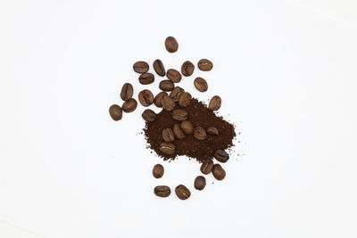 High angle view of coffee beans against white background