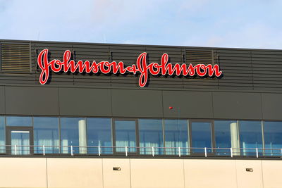 Low angle view of illuminated sign against sky