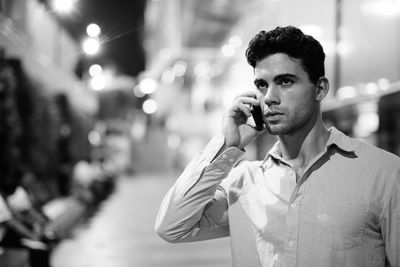 Young man using smart phone outdoors