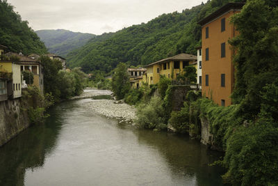 Bridge over river amidst houses