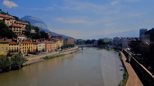 River amidst buildings against sky