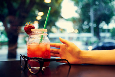 Close-up of hand holding glass with drink