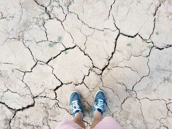 Low section of person standing on tiled floor