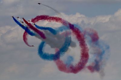 Low angle view of airshow against sky