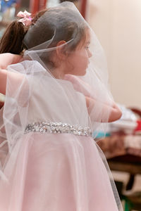 Beautiful girl playing with her formal dress while trying it on