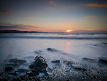 Scenic view of sea against sky at sunset