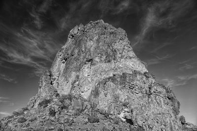 Low angle view of rock formation against sky