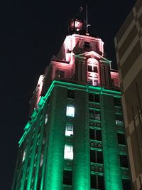 Low angle view of illuminated building against sky at night