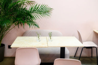 Empty chairs and table against wall at home