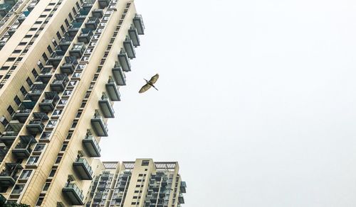 Low angle view of buildings in city against sky
