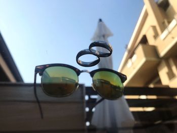 Low angle view of sunglasses against clear sky