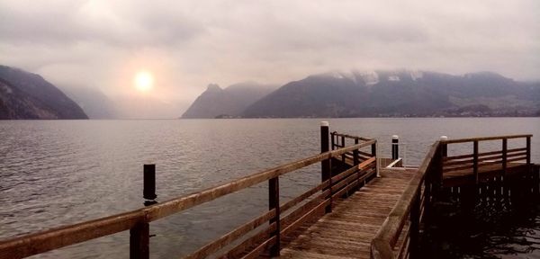 Scenic view of sea and mountains against sky