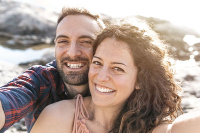 Portrait of smiling couple at beach