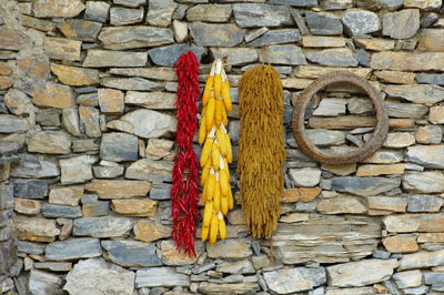 Yellow flowers on stone wall