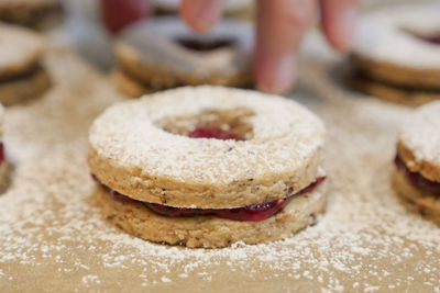 Close-up of fresh homemade cookie with powdered sugar on table