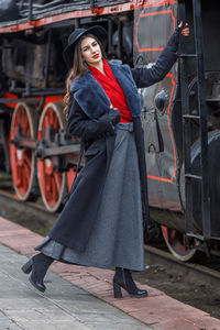 Low section of woman standing in train