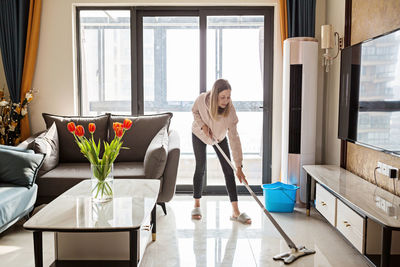 Rear view of woman working at home