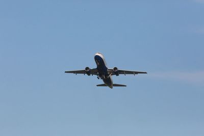 Low angle view of airplane flying in sky