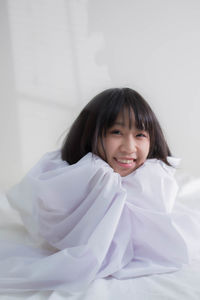 Portrait of a smiling girl on bed