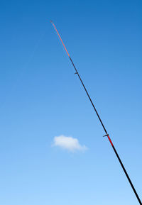 Low angle view of vapor trail against blue sky