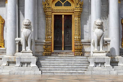 Pair of marble lions in front of the door of the marble temple in bangkok, most beautiful temple.