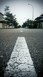 Empty road along trees