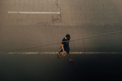 High angle view of man walking on road 