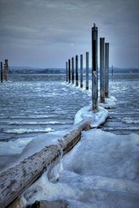 Scenic view of sea against sky during winter