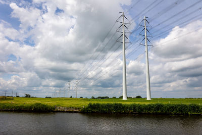 Scenic view of agricultural field against cloudy sky