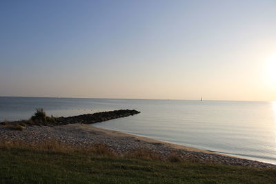 Scenic view of sea against clear sky during sunset