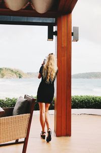Full length rear view of woman standing at observation point