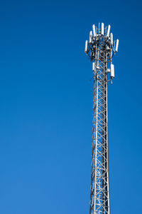 Telecommunication phone signal tower on sky background