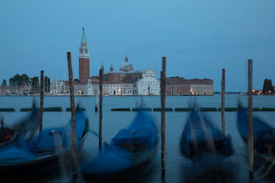 Gondolas on grand canal against sky in city