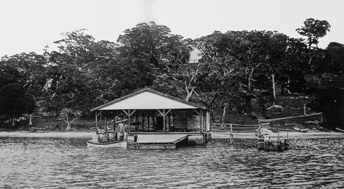 Gazebo by lake against building