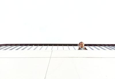 Portrait of man sitting on railing