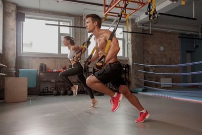 Full length of woman exercising in gym